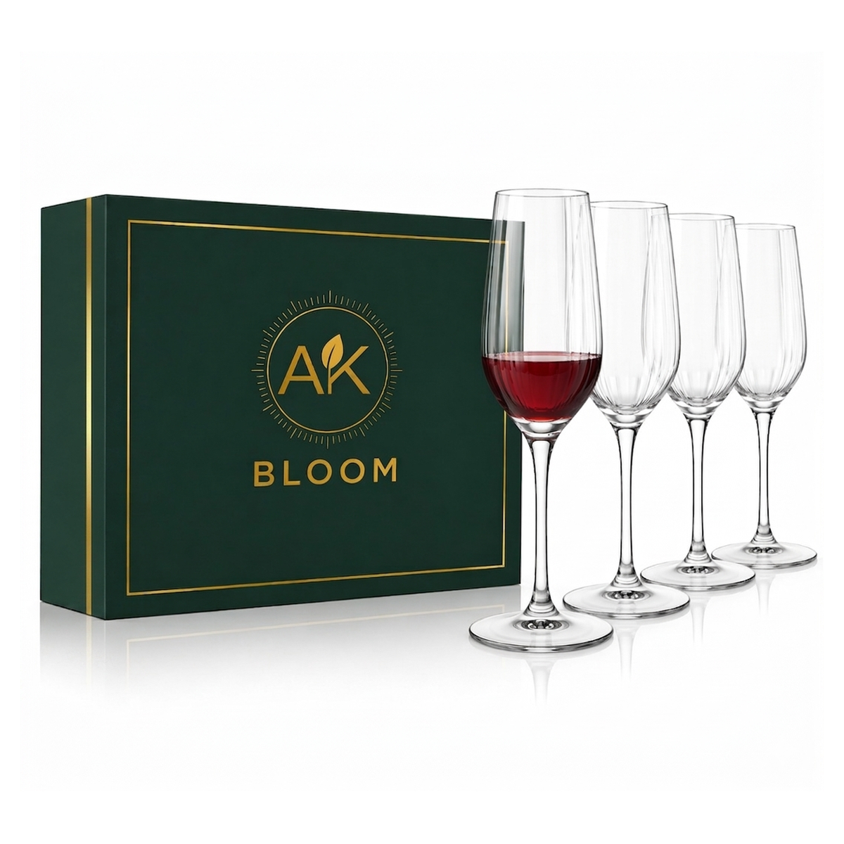 AK BLOOM set of 4 clear stemmed wine glasses, one partially filled with red wine, displayed beside a dark green gift box with gold trim.